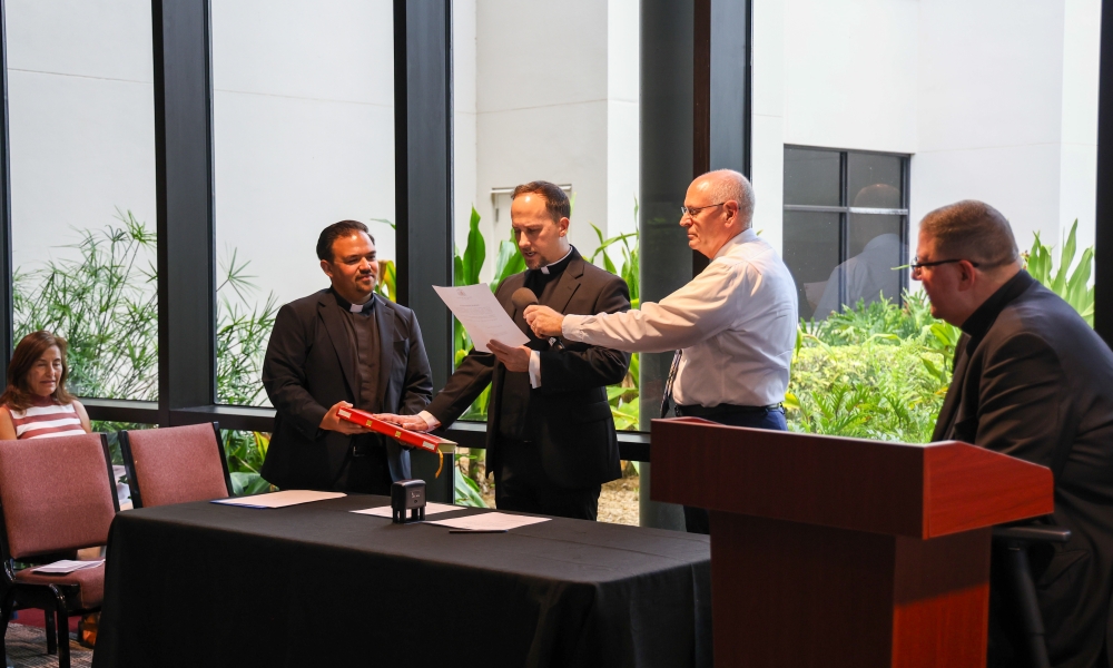 Father Andrew Burns takes the Oath of Fidelity. Photo by Allison Munden.