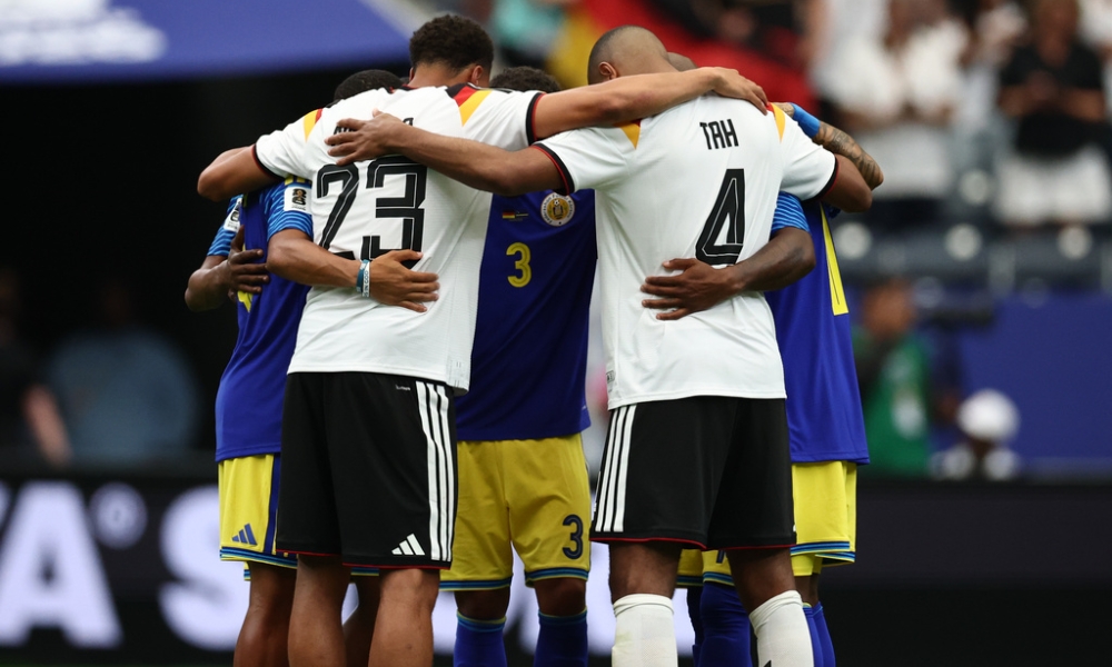 Felix Nmecha (Germany) and Jonathan Tah (Germany) pray with players from Curaçao after the German team’s 7-1 first-day Group E FIFA World Cup win on June 14, 2026, in Houston. | Credit: Christian Charisius/picture-alliance/dpa/AP Images