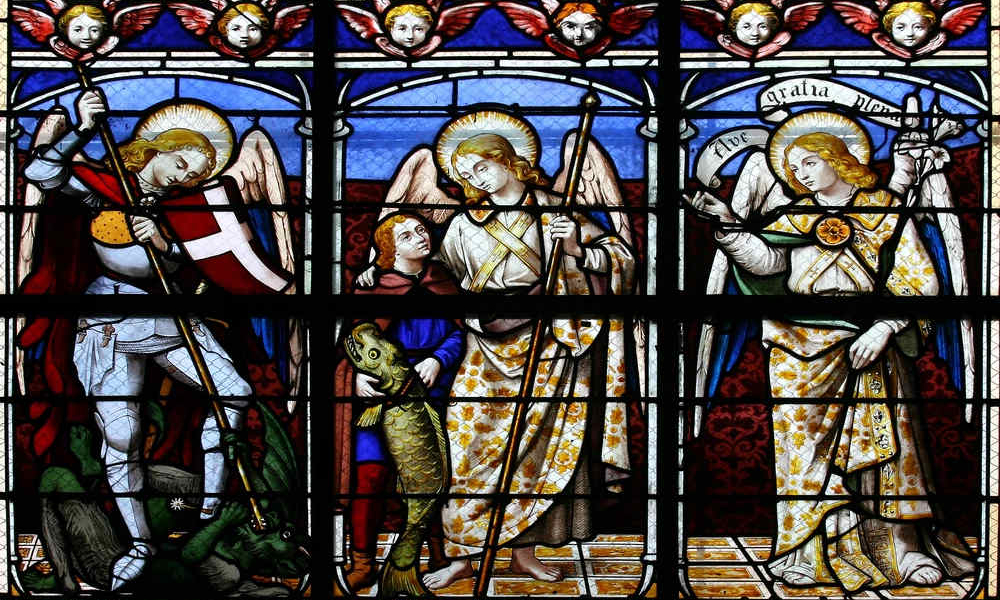A stained-glass window in St. Sulpice Church in Fougeres, France, depicts (from left to right) the archangels Michael, Raphael, and Gabriel. | Credit: Tiberiu Stan/Shutterstock