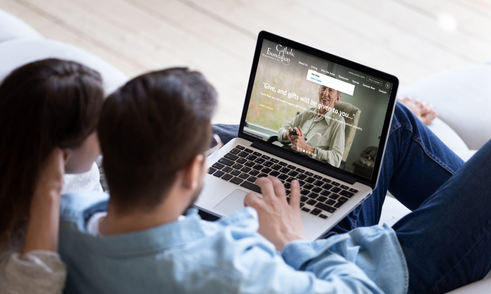 couple looking at Catholic Foundation website