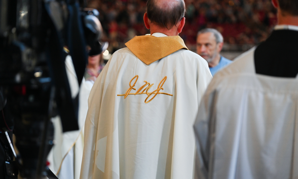 A priest wears the vestments provided for the Beatification Mass, featuring "JMJ" in Blessed Fulton Sheen's handwriting. | Photo by Brittany DeHaan
