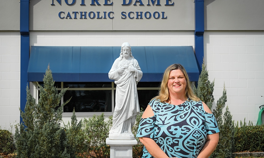 Elise Buckner stands outside of Notre Dame Catholic School where she teaches