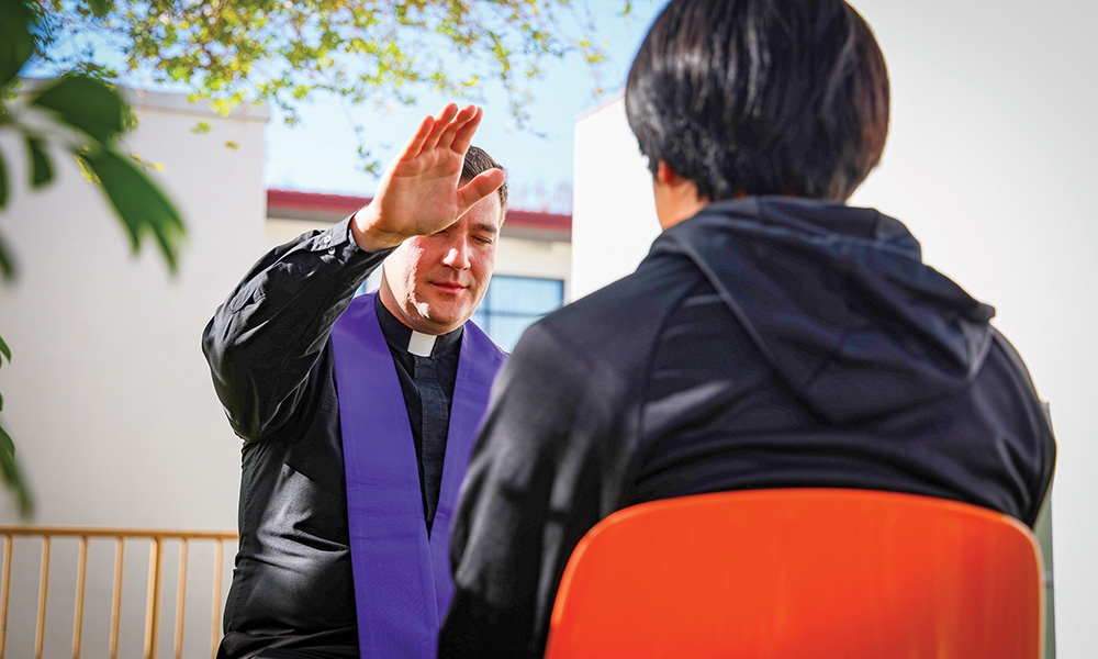 Father Ralph D’Elia hears a teen’s confession.