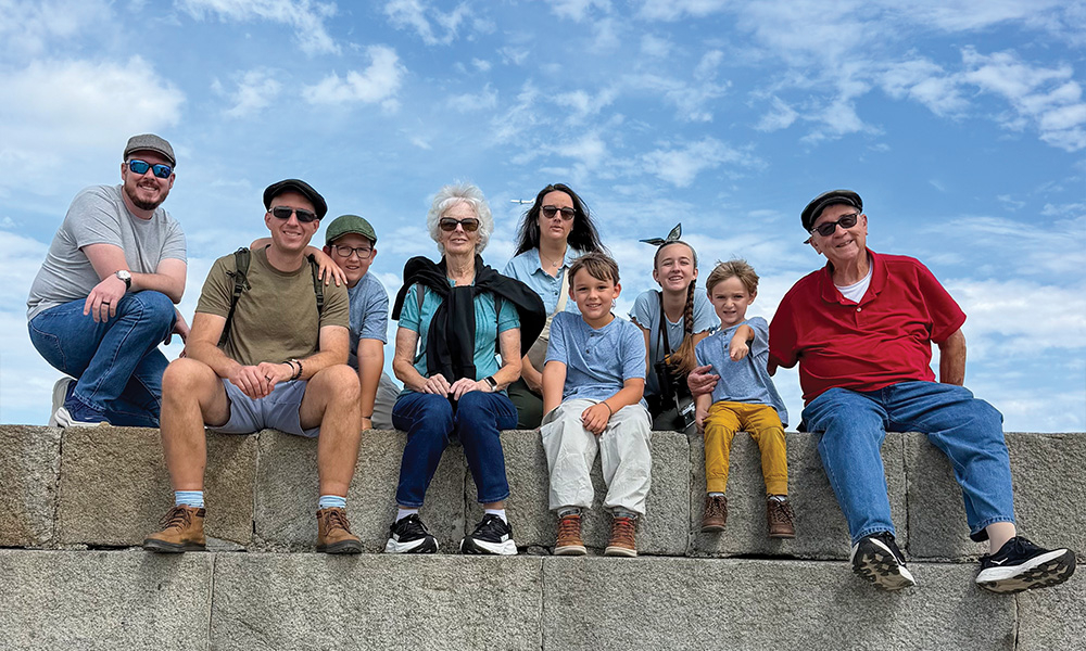 Family sitting on a brick wall