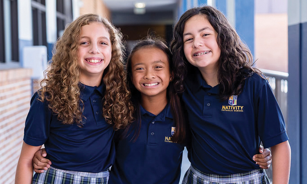 Three schoolgirls smiling